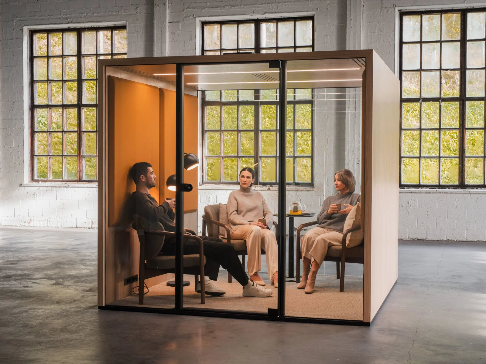 Taiga Concept Lohko Box 5 meeting pod with three people seated inside