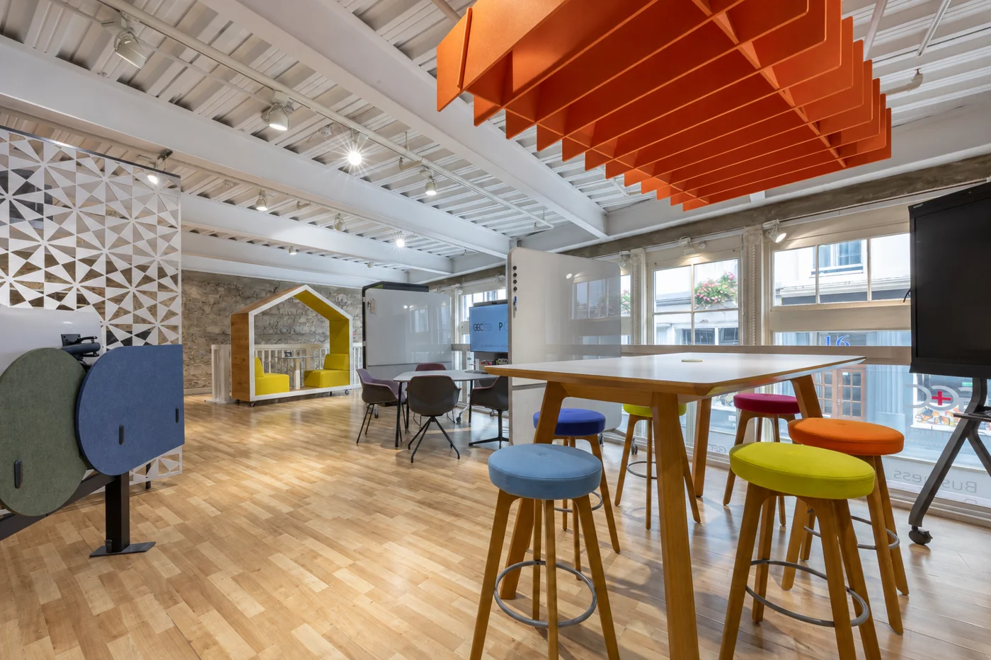 Collaborative tables, colourful stools and acoustic baffles at the POS showroom in Guernsey Chamber of Commerce